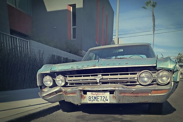 Beat up vintage blue Oldsmobile with California plates